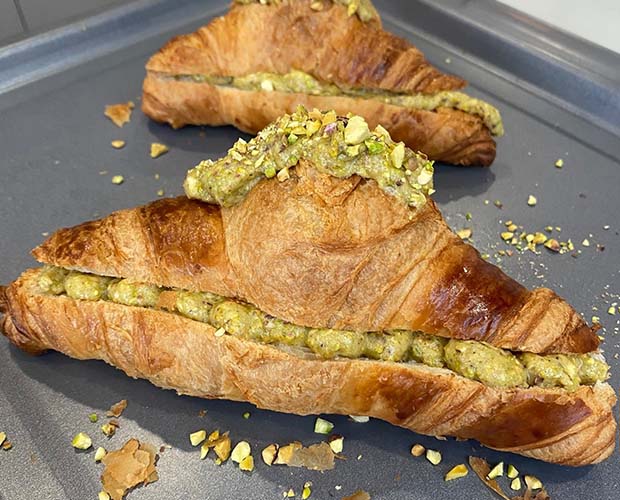 close up of a croissants filled a sweet pistachio filling