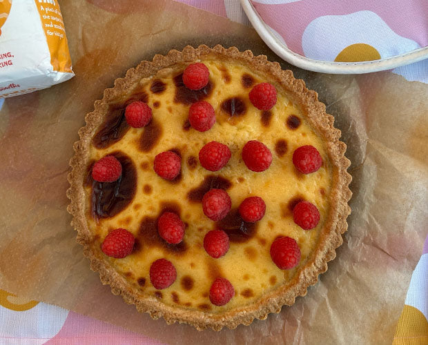 Portuguese tart served with rapsberries