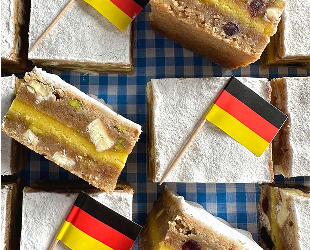 sliced stollen blondies, topped with icing sugar and German flags
