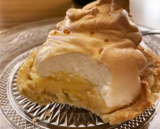 an individual lemon meringue pie on a plate