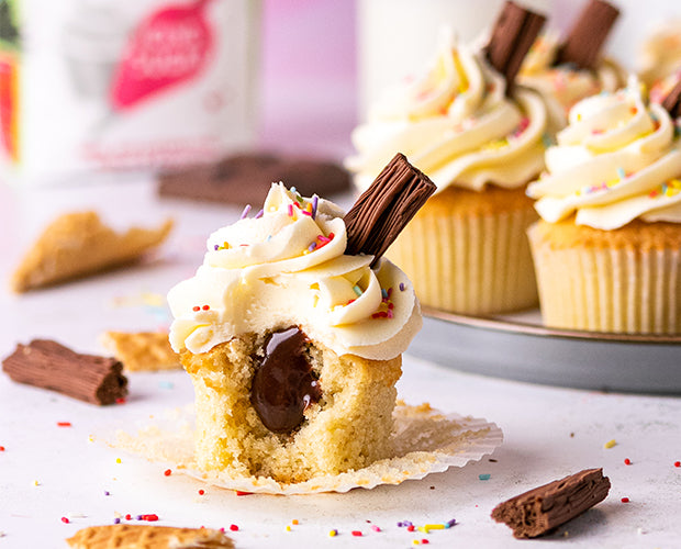 Vanilla sponge cupcakes with a chocolate ganache centre, topped with vanilla buttercream, sprinkles and a flake