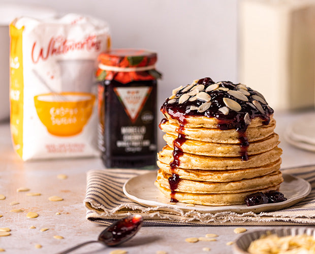 Almond pancake stack topped with cherry jam