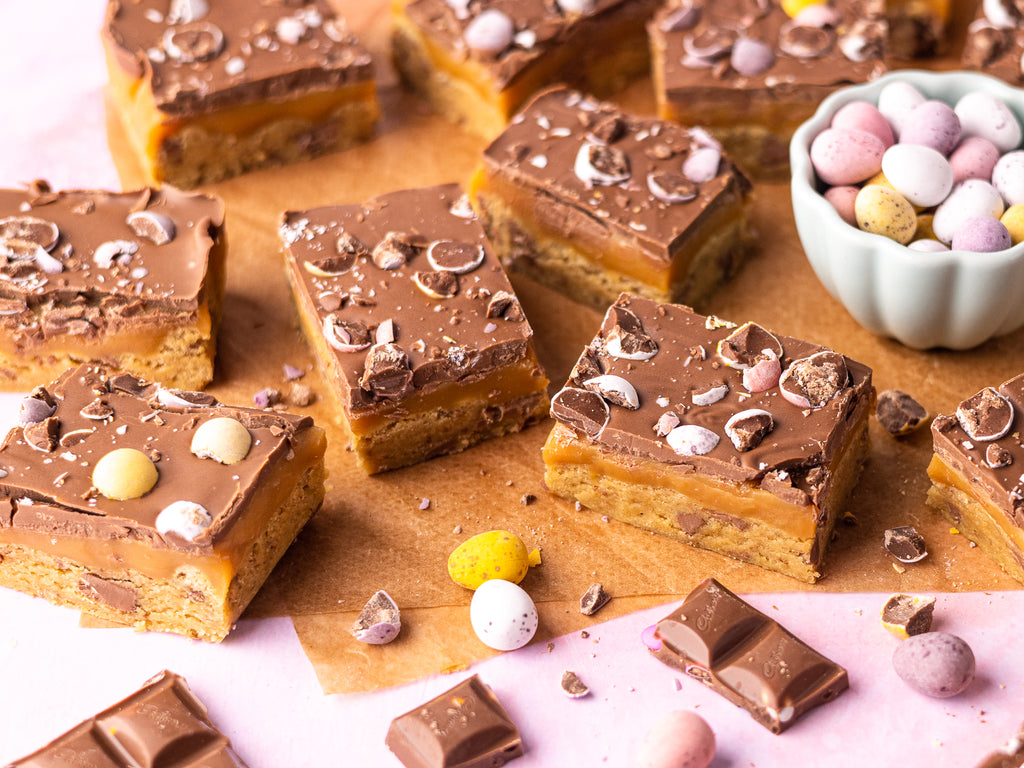 Easter Millionaire Cookie Bars: A mini egg cookie base, thick caramel layer, topped with milk chocolate and mini eggs