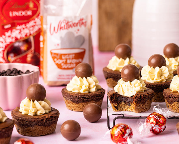 Brookie cups topped with cream and maltesers chocolate