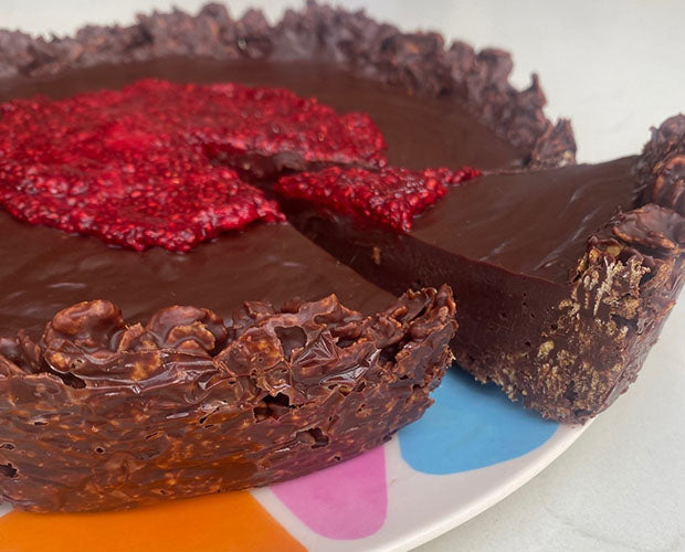 chocolate tart close up, topped with massed raspberry