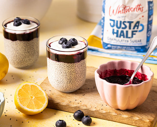 A galss filled with Lemon & Blueberry Chia Pudding with a delicious compote