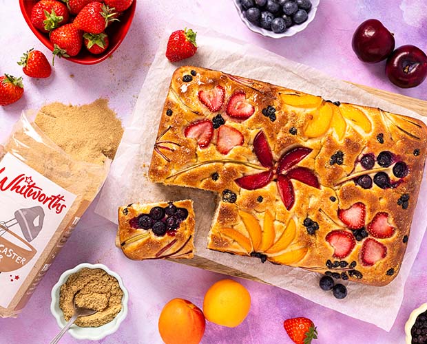Sweet focaccia decorated with seasonal fruits making flower shapes