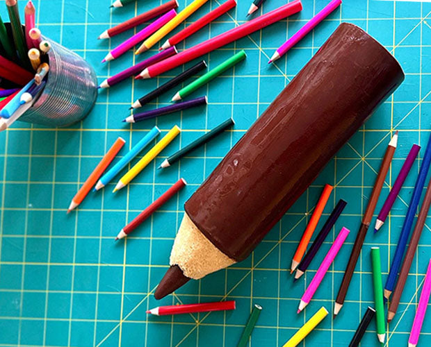 pencil shaped cake with chocolate lead and coating