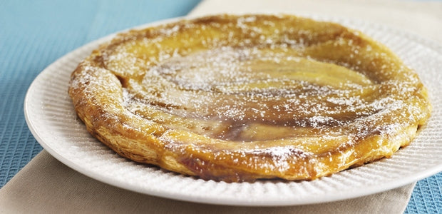 A banana puff pastry tart on a plate