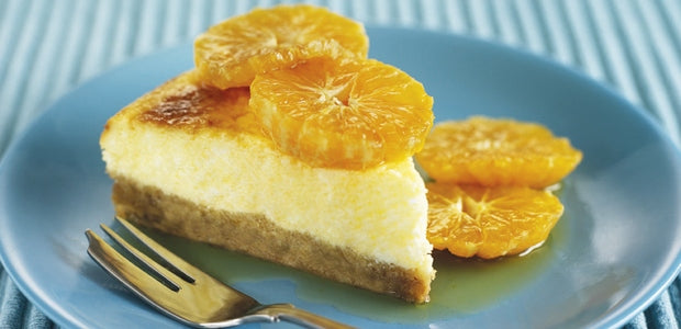 A vanilla cheesecake slice topped with oranges