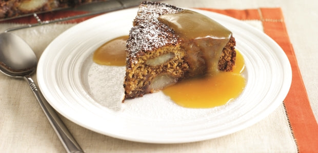 Slice of ginger and pear cake with toffee sauce