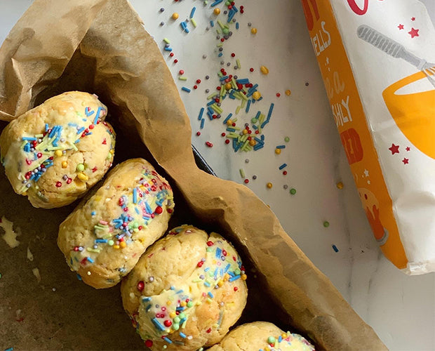 Ice cream sandwiches in a tin covered with sprinkles