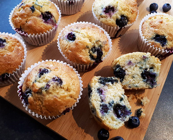 Mini blueberry muffins on a wooden tray