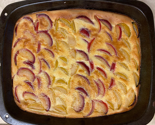 View of a plum custard pudding in a tray