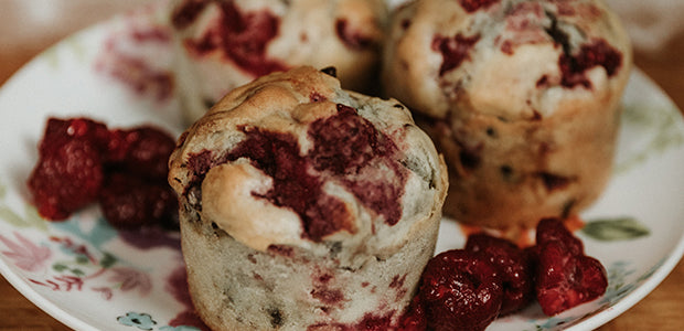 a plate of red berry muffins