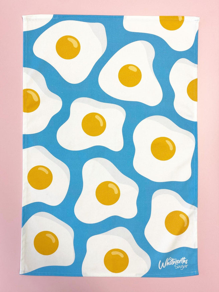 Flat lay of Whitworths Blue Sunny Egg tea towel